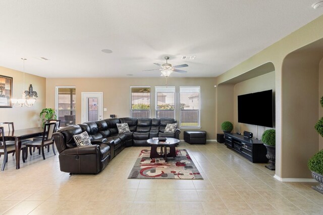 18401 Pencil Cactus Dr, Pflugerville, TX 78660 - living area with light tile patterned floors, a chandelier, arched walkways, and ceiling fan
