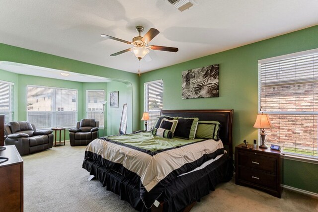 18401 Pencil Cactus Dr, Pflugerville, TX 78660 - bedroom with light colored carpet, multiple windows, and a ceiling fan