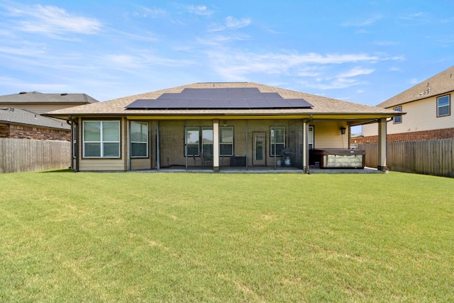 18401 Pencil Cactus Dr, Pflugerville, TX 78660 - back of property featuring a hot tub, a patio area, a fenced backyard, solar panels, and roof with shingles