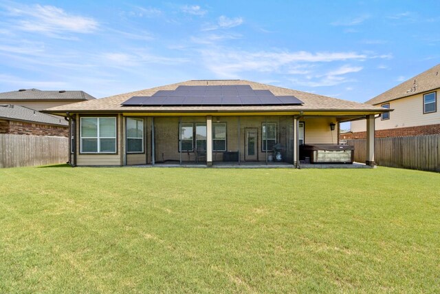 18401 Pencil Cactus Dr, Pflugerville, TX 78660 - rear view of house featuring a hot tub, a patio area, a fenced backyard, solar panels, and roof with shingles