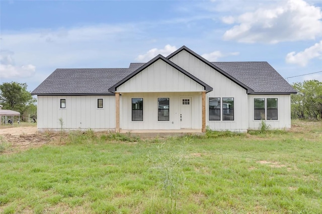 138 Blushing Dr, Cedar Creek, TX 78612 - back of property with a shingled roof, a lawn, and board and batten siding