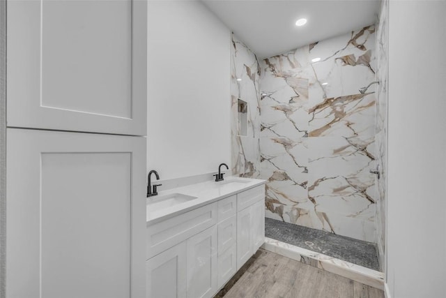 138 Blushing Dr, Cedar Creek, TX 78612 - bathroom with a marble finish shower, wood finished floors, double vanity, and recessed lighting