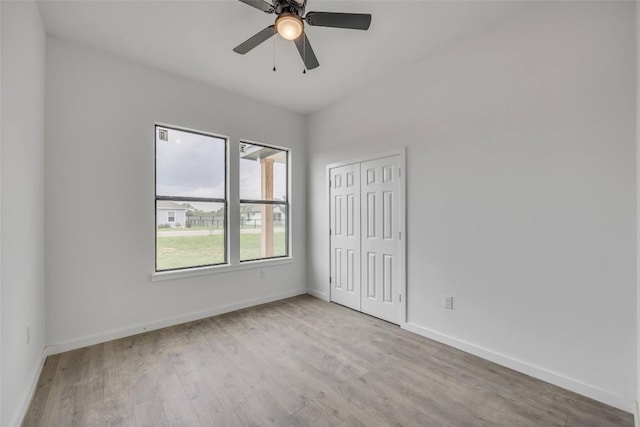 138 Blushing Dr, Cedar Creek, TX 78612 - unfurnished bedroom featuring wood finished floors, baseboards, a closet, and ceiling fan