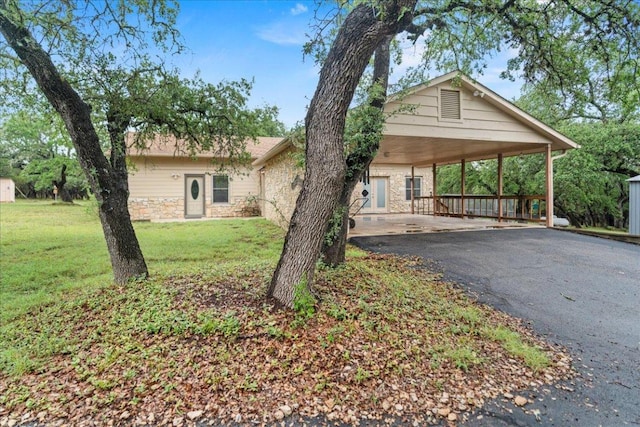 721 Deer Run, Wimberley, TX 78676 - view of front facade featuring asphalt driveway, a front yard, and stone siding