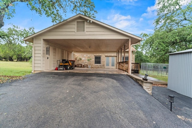 721 Deer Run, Wimberley, TX 78676 - view of front of home featuring french doors, a carport, and driveway