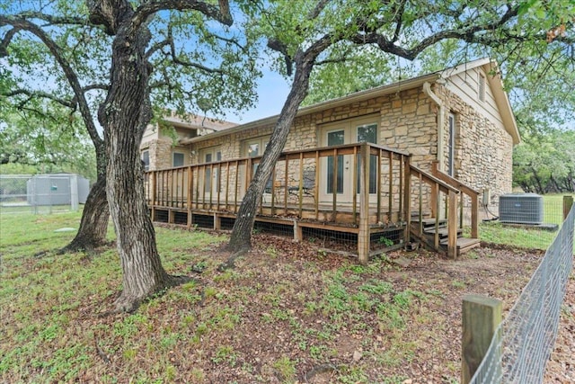 721 Deer Run, Wimberley, TX 78676 - rear view of house with stone siding and a deck