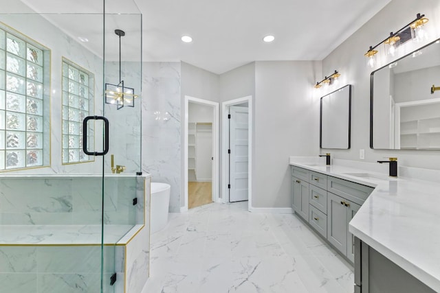 210 Las Colinas Dr, Georgetown, TX 78628 - full bathroom with double vanity, marble finish flooring, a walk in closet, healthy amount of natural light, and recessed lighting