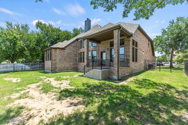 210 Las Colinas Dr, Georgetown, TX 78628 - rear view of property with brick siding, a chimney, and central AC