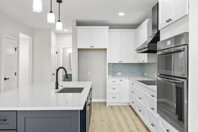 210 Las Colinas Dr, Georgetown, TX 78628 - kitchen with a sink, double oven, wall chimney exhaust hood, black electric cooktop, and gray cabinetry