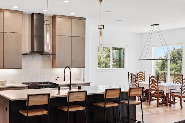 120 July Johnson Dr, Austin, TX 78737 - kitchen with wall chimney exhaust hood, modern cabinets, backsplash, light stone counters, and recessed lighting