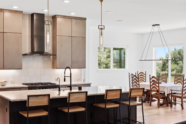120 July Johnson Dr, Austin, TX 78737 - kitchen with wall chimney range hood, modern cabinets, tasteful backsplash, light stone countertops, and recessed lighting