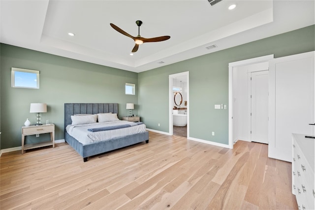 120 July Johnson Dr, Austin, TX 78737 - bedroom featuring a raised ceiling, light wood-style floors, recessed lighting, ensuite bath, and baseboards