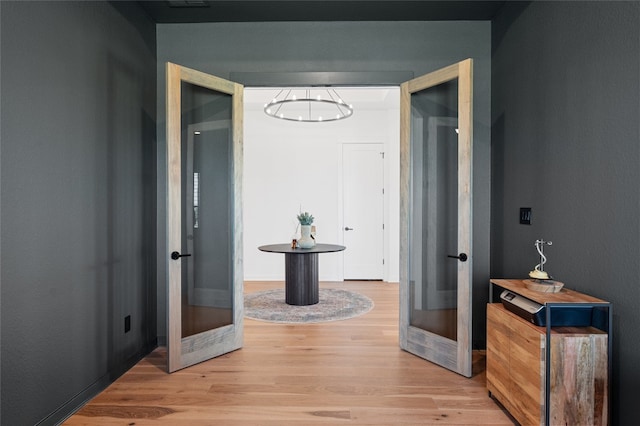 120 July Johnson Dr, Austin, TX 78737 - corridor featuring french doors, light wood-type flooring, and a chandelier