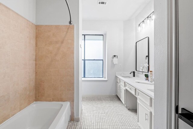 1706 Prairie Hen Cv, Austin, TX 78758 - full bath featuring double vanity, tile patterned floors, baseboards, and tub / shower combination