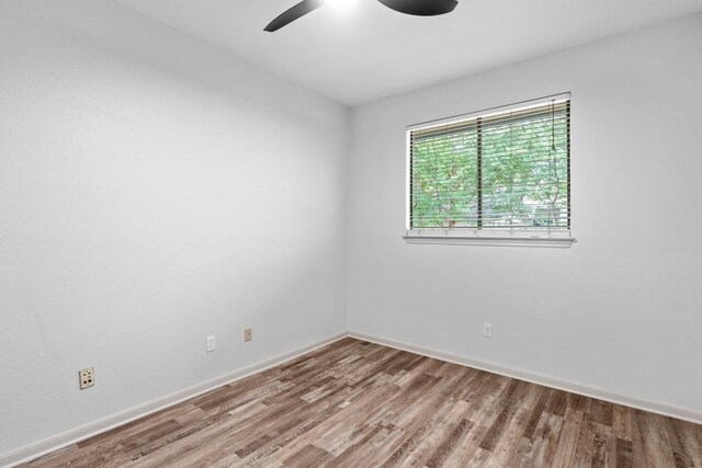 1706 Prairie Hen Cv, Austin, TX 78758 - empty room featuring wood finished floors, a ceiling fan, and baseboards