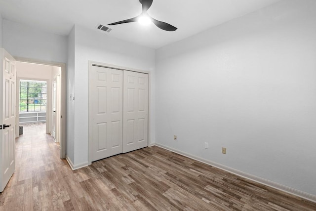 1706 Prairie Hen Cv, Austin, TX 78758 - unfurnished bedroom with light wood-style flooring, baseboards, a closet, and ceiling fan