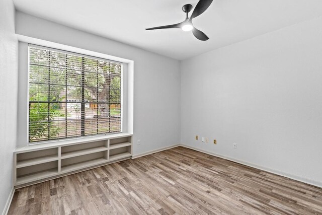 1706 Prairie Hen Cv, Austin, TX 78758 - unfurnished room with wood finished floors, a ceiling fan, and baseboards