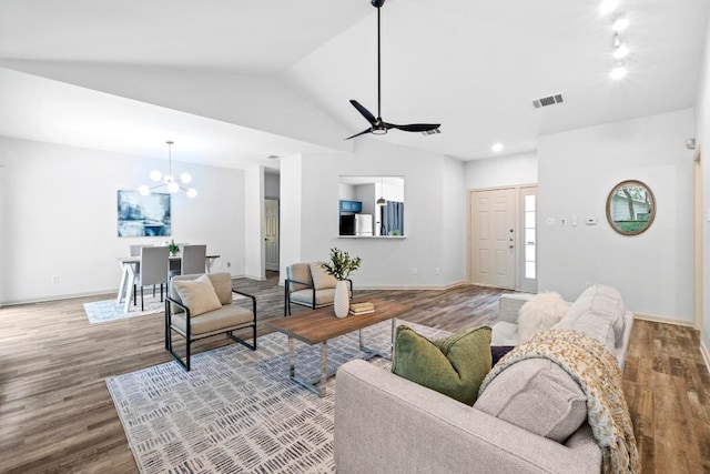 1706 Prairie Hen Cv, Austin, TX 78758 - living room featuring wood finished floors, a chandelier, lofted ceiling, and baseboards