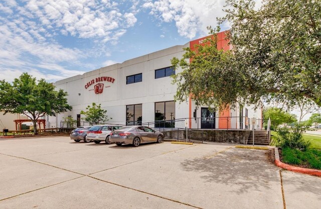 1706 Prairie Hen Cv, Austin, TX 78758 - view of building exterior featuring uncovered parking and stairway
