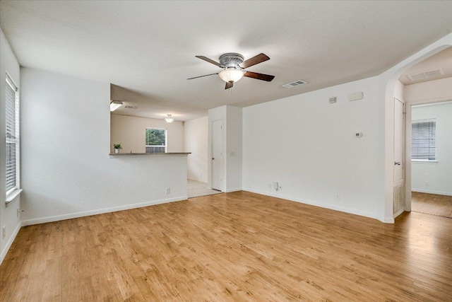 8520 Chick Pea Ln, Austin, TX 78748 - unfurnished room featuring light wood-type flooring, ceiling fan, arched walkways, and baseboards