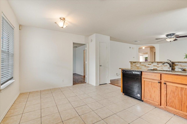 8520 Chick Pea Ln, Austin, TX 78748 - kitchen featuring black dishwasher, a sink, arched walkways, backsplash, and ceiling fan