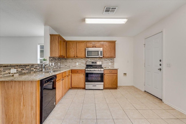 8520 Chick Pea Ln, Austin, TX 78748 - kitchen with appliances with stainless steel finishes, a sink, decorative backsplash, and light tile patterned floors