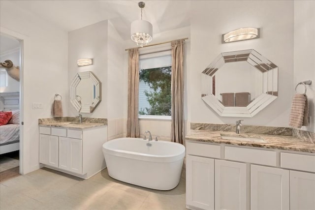 19506 Inverness Dr, Lakeway, TX 78669 - ensuite bathroom with two vanities, a freestanding bath, and tile patterned floors