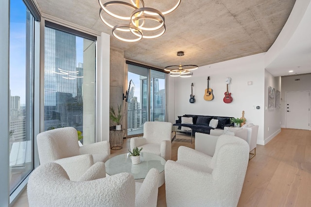360 Nueces St Unit 1811, Austin, TX 78701 - living room featuring a chandelier, a wall of windows, light wood-type flooring, baseboards, and a city view
