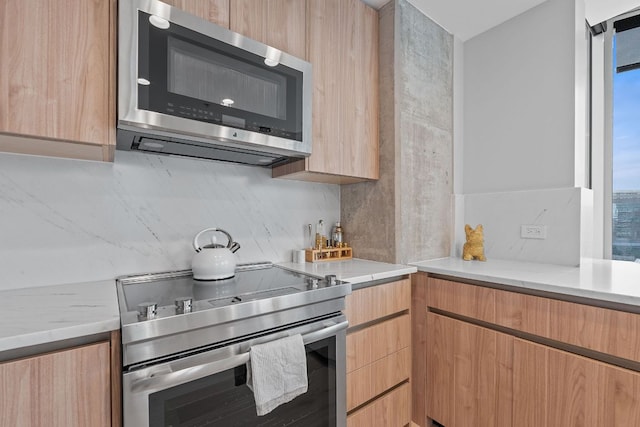 360 Nueces St Unit 1811, Austin, TX 78701 - kitchen with stainless steel appliances, light brown cabinets, modern cabinets, light stone countertops, and backsplash