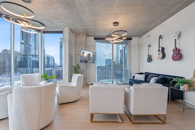 360 Nueces St Unit 1811, Austin, TX 78701 - living room with a chandelier, expansive windows, healthy amount of natural light, and light wood finished floors
