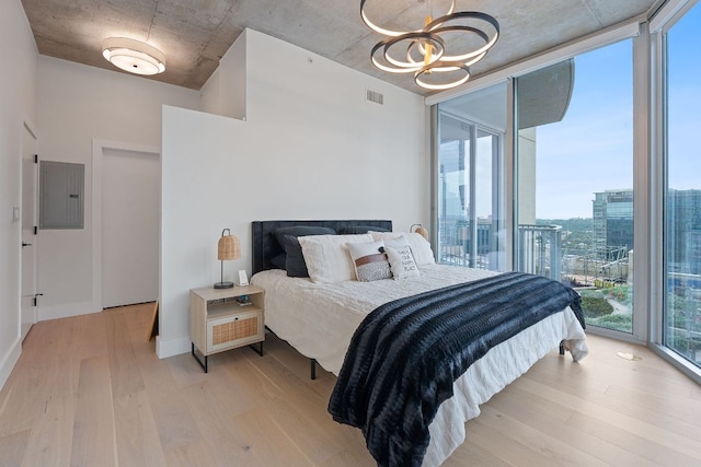 360 Nueces St Unit 1811, Austin, TX 78701 - bedroom with electric panel, a wall of windows, light wood-type flooring, a chandelier, and access to outside