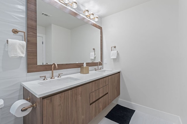 360 Nueces St Unit 1811, Austin, TX 78701 - bathroom featuring double vanity and baseboards