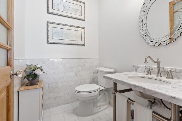 2449 Crosswind Dr, Lakeway, TX 78669 - bathroom with toilet, tile walls, a wainscoted wall, and vanity