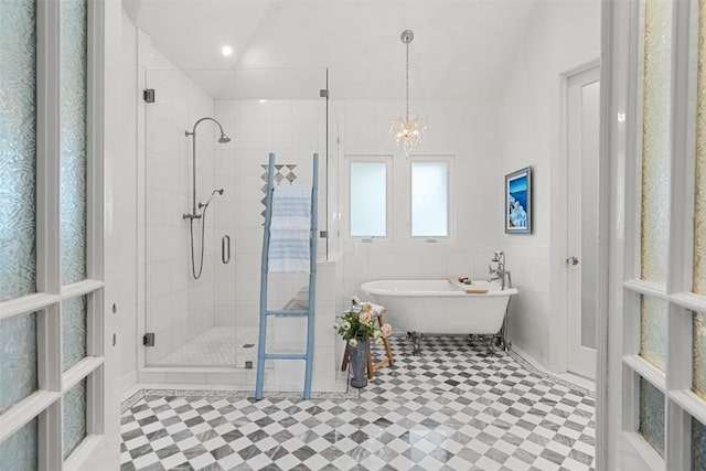 2449 Crosswind Dr, Lakeway, TX 78669 - bathroom with a freestanding bath, a stall shower, a chandelier, and tile patterned floors