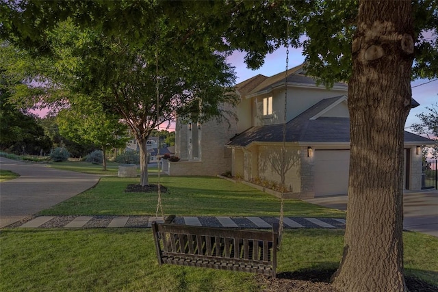 2449 Crosswind Dr, Lakeway, TX 78669 - view of front facade featuring a yard, stucco siding, and an attached garage