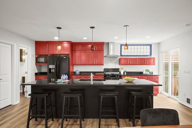 4116 Creek Ledge Unit 108, Austin, TX 78731 - kitchen with wall chimney range hood, black appliances, reddish brown cabinets, dark countertops, and recessed lighting