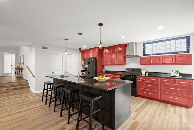 4116 Creek Ledge Unit 108, Austin, TX 78731 - kitchen with wall chimney exhaust hood, black appliances, dark brown cabinets, dark countertops, and recessed lighting