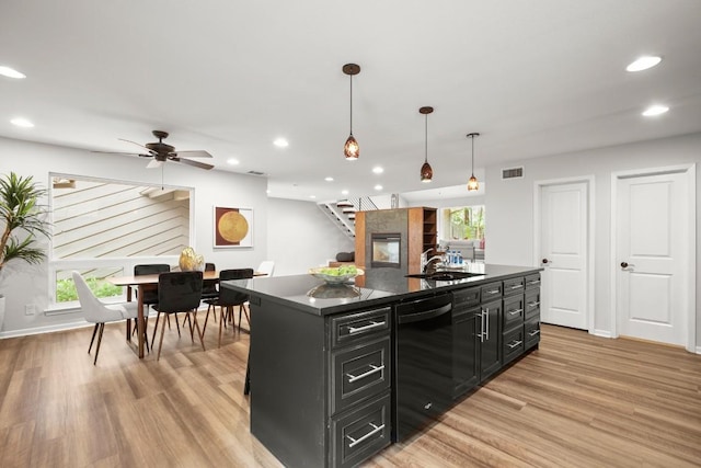 4116 Creek Ledge Unit 108, Austin, TX 78731 - kitchen with dishwasher, dark cabinetry, dark countertops, plenty of natural light, and recessed lighting