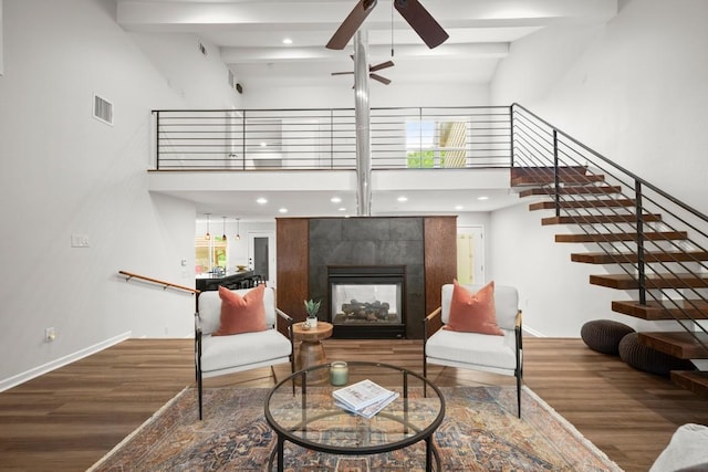 4116 Creek Ledge Unit 108, Austin, TX 78731 - living room featuring a ceiling fan, wood finished floors, beam ceiling, a towering ceiling, and baseboards