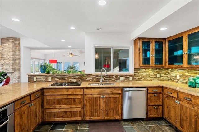922 Challenger, Lakeway, TX 78734 - kitchen featuring dishwasher, a sink, brown cabinets, light stone counters, and recessed lighting