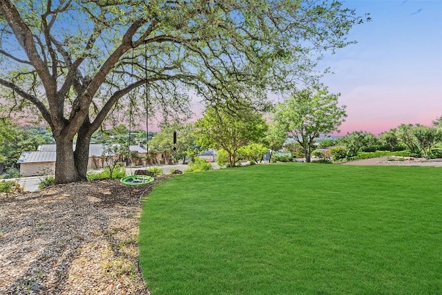 922 Challenger, Lakeway, TX 78734 - yard at dusk featuring a lawn