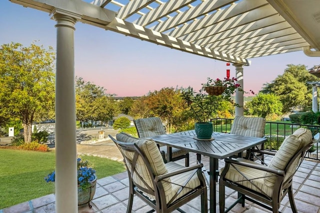 922 Challenger, Lakeway, TX 78734 - patio terrace at dusk featuring a pergola, outdoor dining area, and a lawn