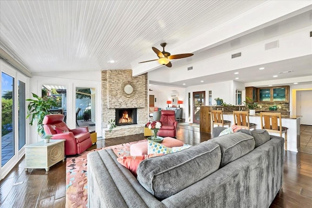 922 Challenger, Lakeway, TX 78734 - living room featuring vaulted ceiling, hardwood / wood-style floors, a stone fireplace, a ceiling fan, and recessed lighting