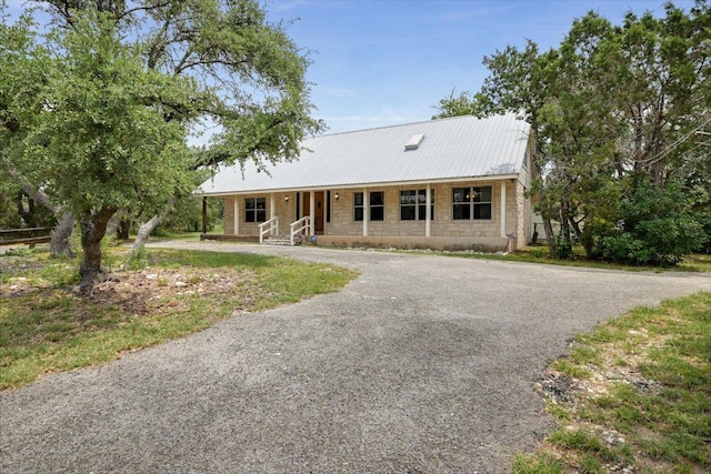 9438 Circle Dr, Austin, TX 78736 - ranch-style house with driveway and metal roof