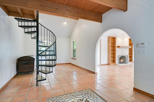 9438 Circle Dr, Austin, TX 78736 - stairs with baseboards, tile patterned flooring, built in features, a large fireplace, and high vaulted ceiling