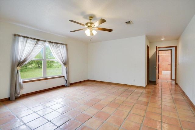 9438 Circle Dr, Austin, TX 78736 - spare room featuring light tile patterned floors, ceiling fan, and baseboards