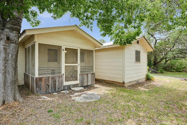 9438 Circle Dr, Austin, TX 78736 - back of property with a sunroom, metal roof, and a lawn