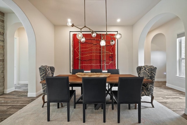 313 Grand Oaks Ln, Georgetown, TX 78628 - dining room featuring wood finished floors, baseboards, arched walkways, and recessed lighting