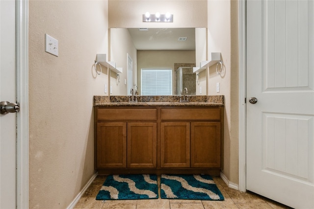 107 Marklawn Ln, Hutto, TX 78634 - bathroom with double vanity, a stall shower, and tile patterned flooring