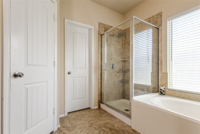 107 Marklawn Ln, Hutto, TX 78634 - full bathroom with a shower stall, a garden tub, and plenty of natural light